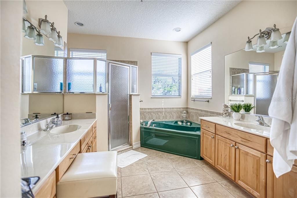 Master Bathroom with Dual Vanities, a garden tub, and separate shower.