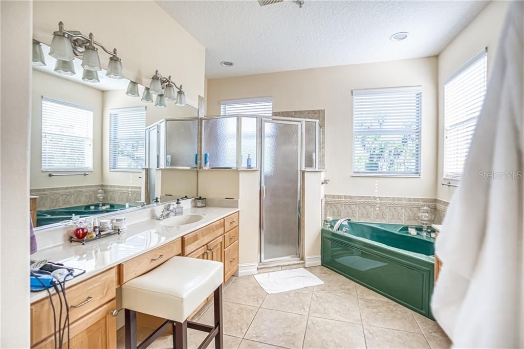 Master Bathroom with Dual Vanities, a garden tub, and separate shower.
