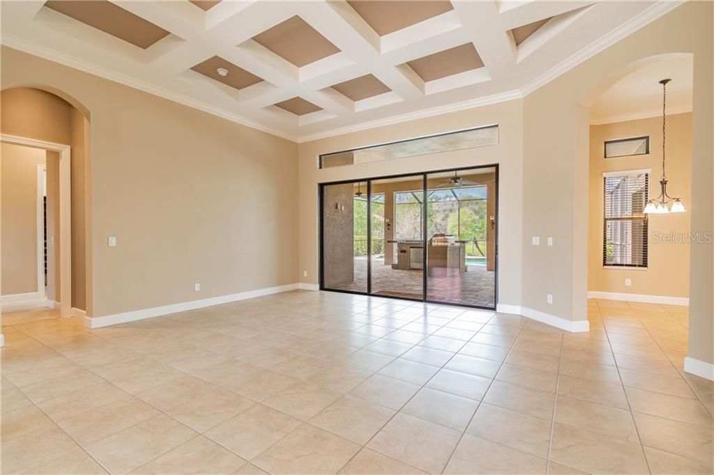 Large Coiffured Ceiling Living Room leading to the Lanai and Pool area