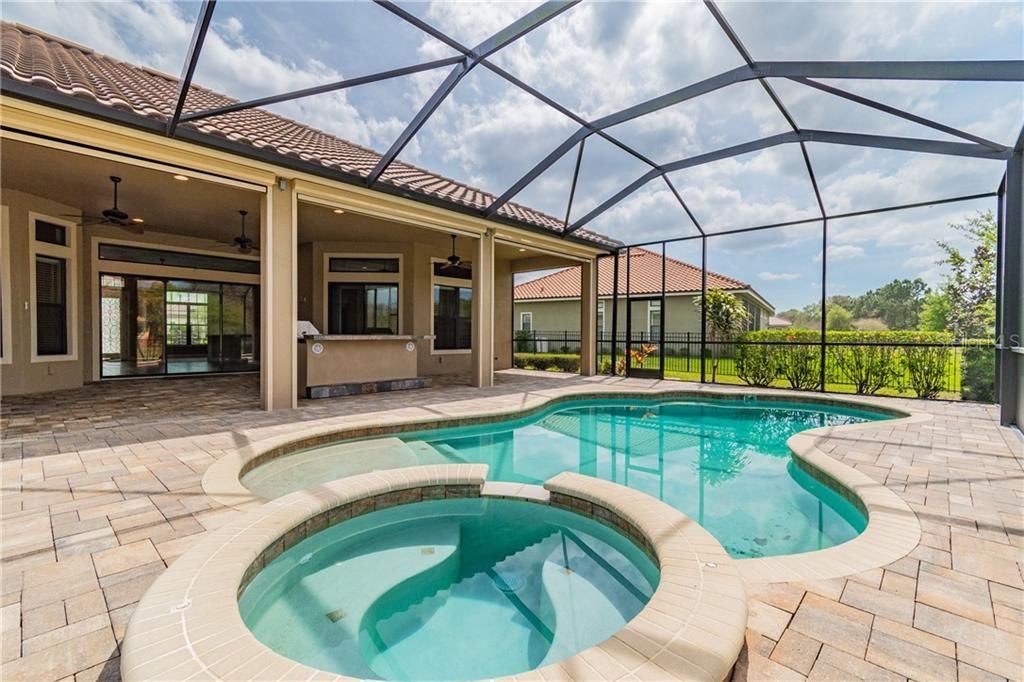 Enjoy the Resort Style Pool and Spa on the Large Paver Lanai with Outdoor Kitchen