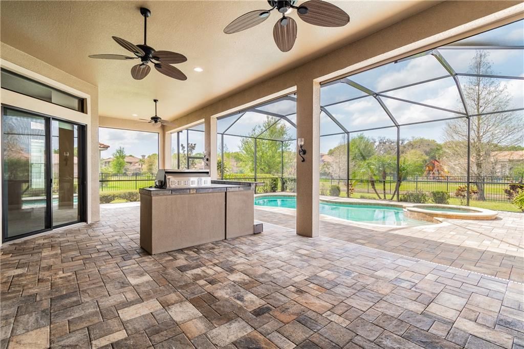 Paver Lanai with L-Shaped Outdoor Kitchen for Entertaining
