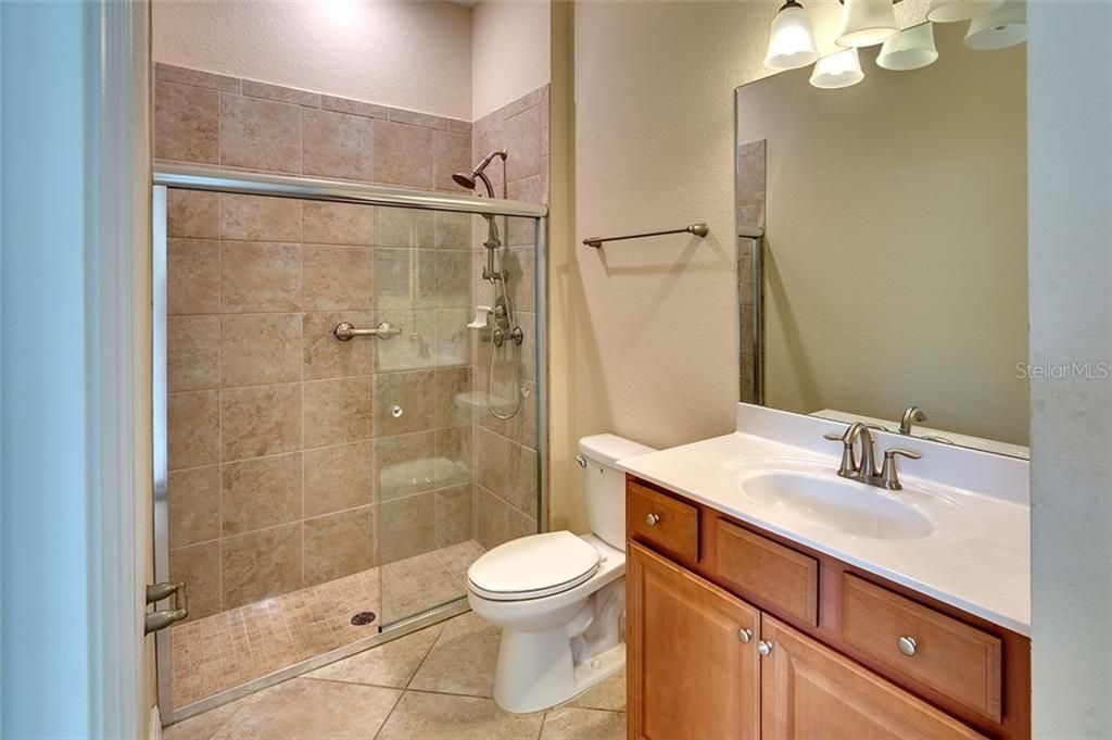 Spacious Bathroom with Walk-In Shower and Tile on the Diagonal