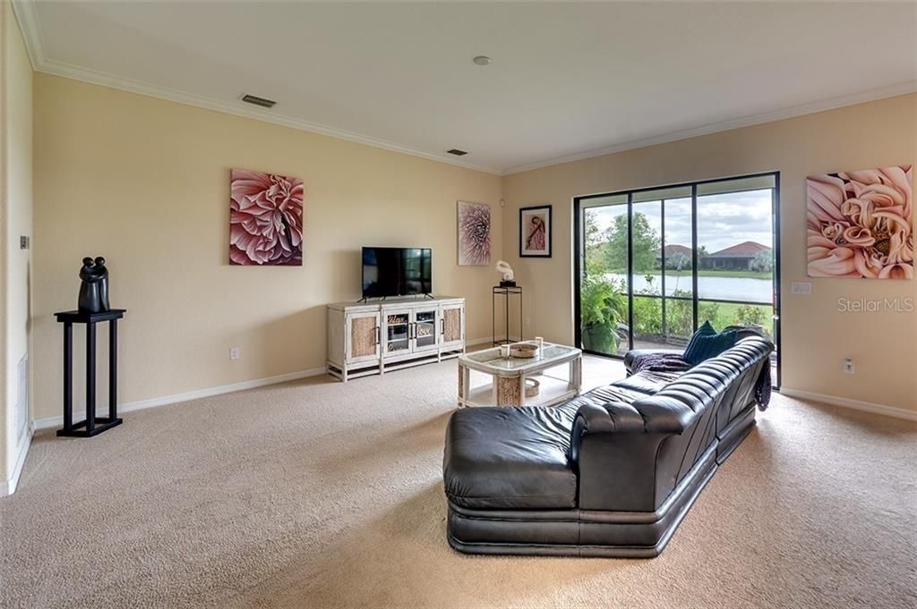 Another Angle of Great Room and Sliding Glass Doors to Lanai with Stellar Lake Views