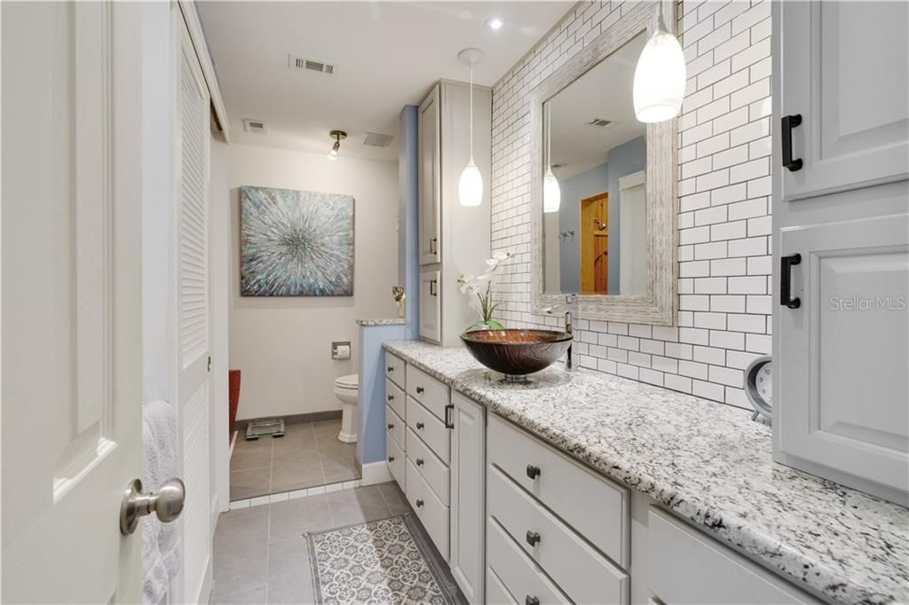 OWNER'S SUITE BATHROOM WITH CUSTOM CABINETRY AND SUBWAY TILE