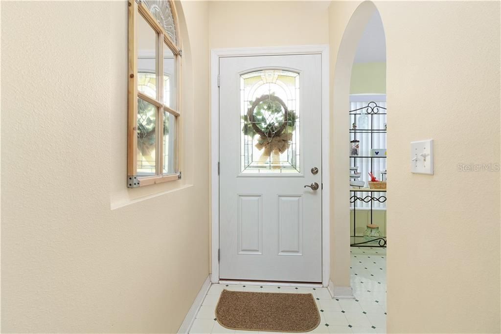 Beveled glass insert in the front door to allow in natural light while also maintaining privacy