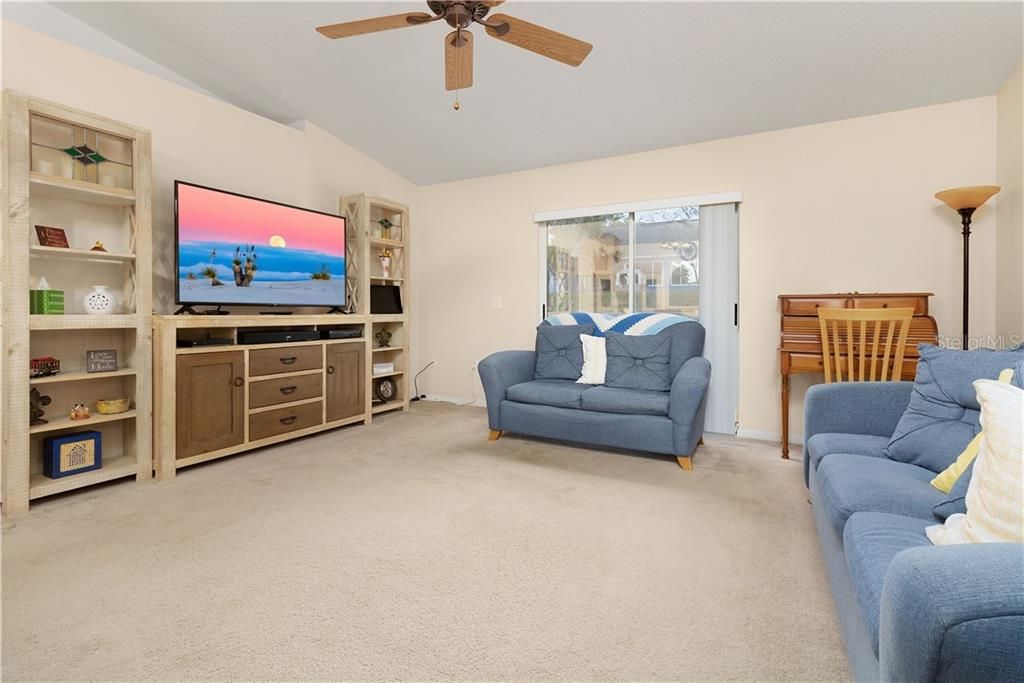 Family room in the middle of the home with sliding glass doors leading to the backyard