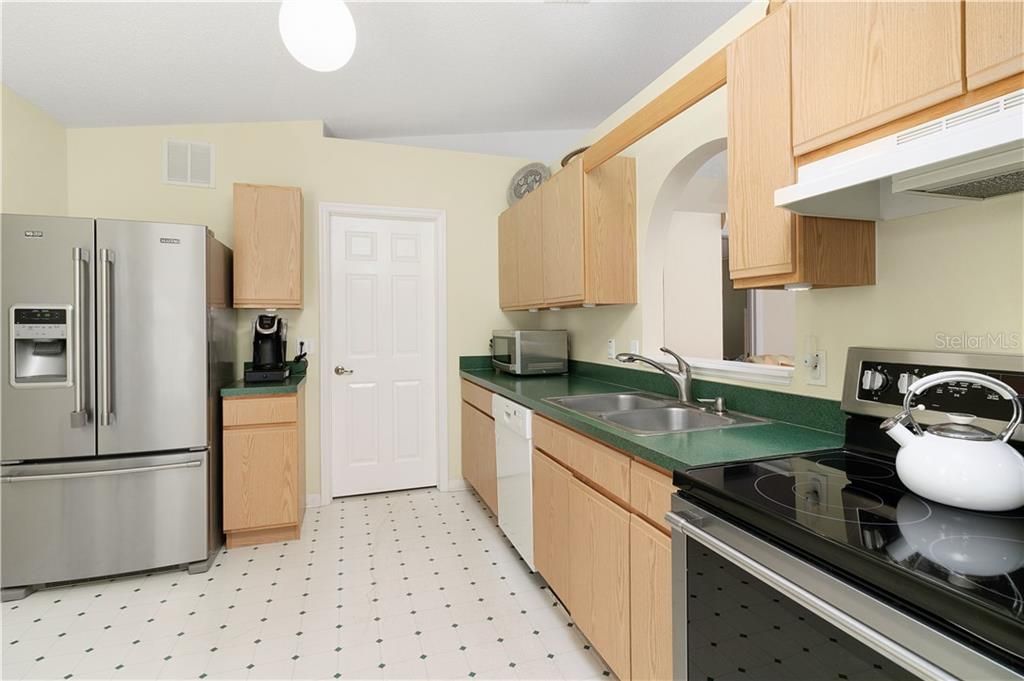 Kitchen with 3 year old stainless steel refrigerator and oven/range