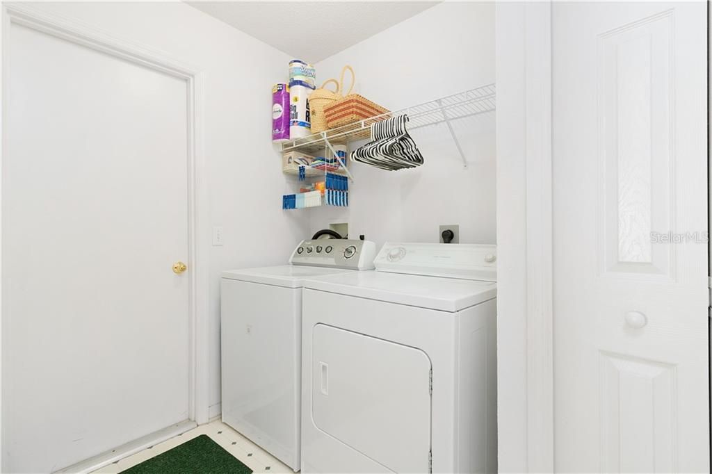 Interior laundry room with a linen/storage closet