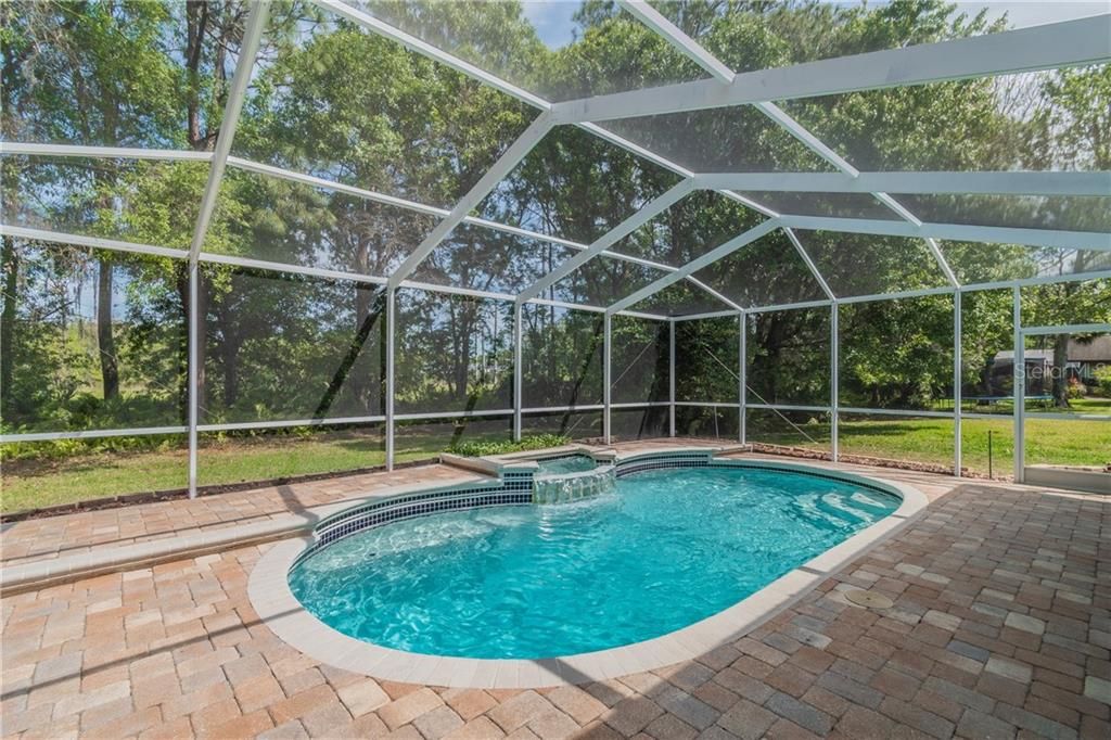 beautiful updated pool area with newer pool resurface and brick pavers