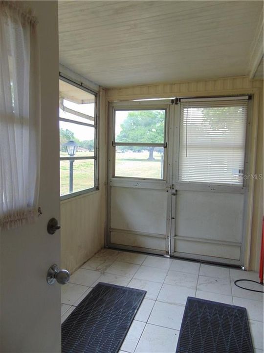 Golf cart storage area with double doors on the side of the unit