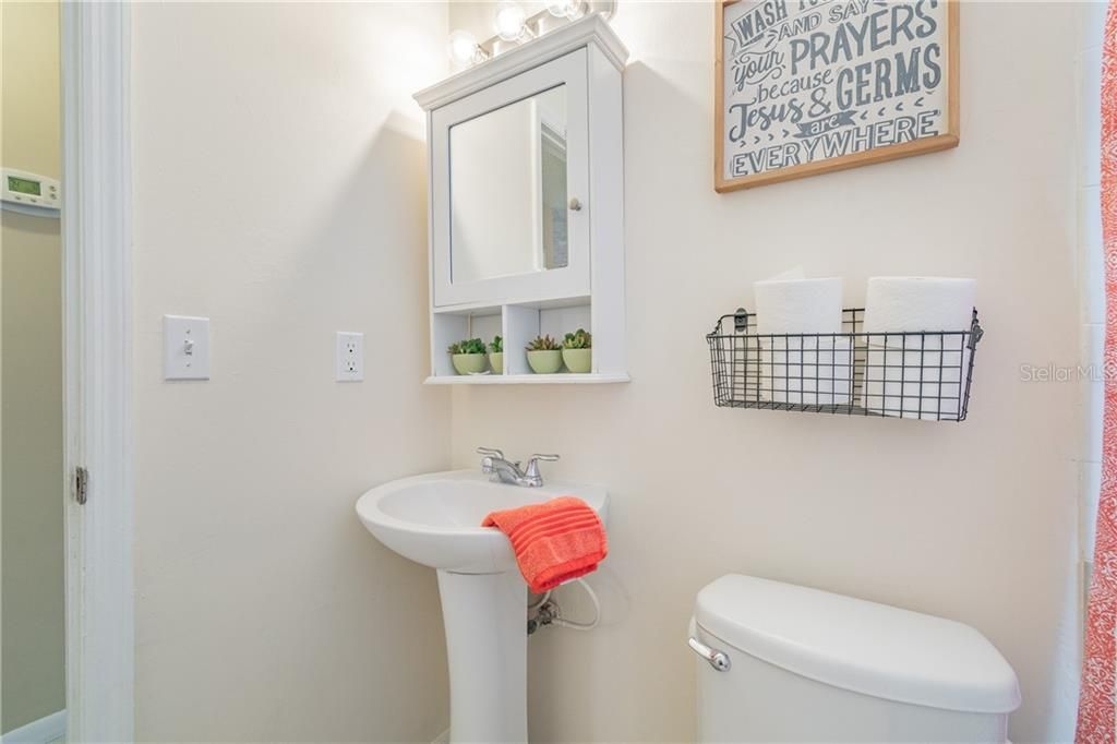 9606 N. Hartts Drive, Tampa, FL 33617 - Bathroom 2 - Features bath with shower & a pedestal sink.