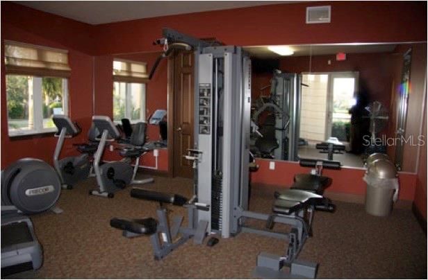 Marina Bay fitness room, featuring Precor treadmills, recumbent bikes, elliptical, weight station equipment..
