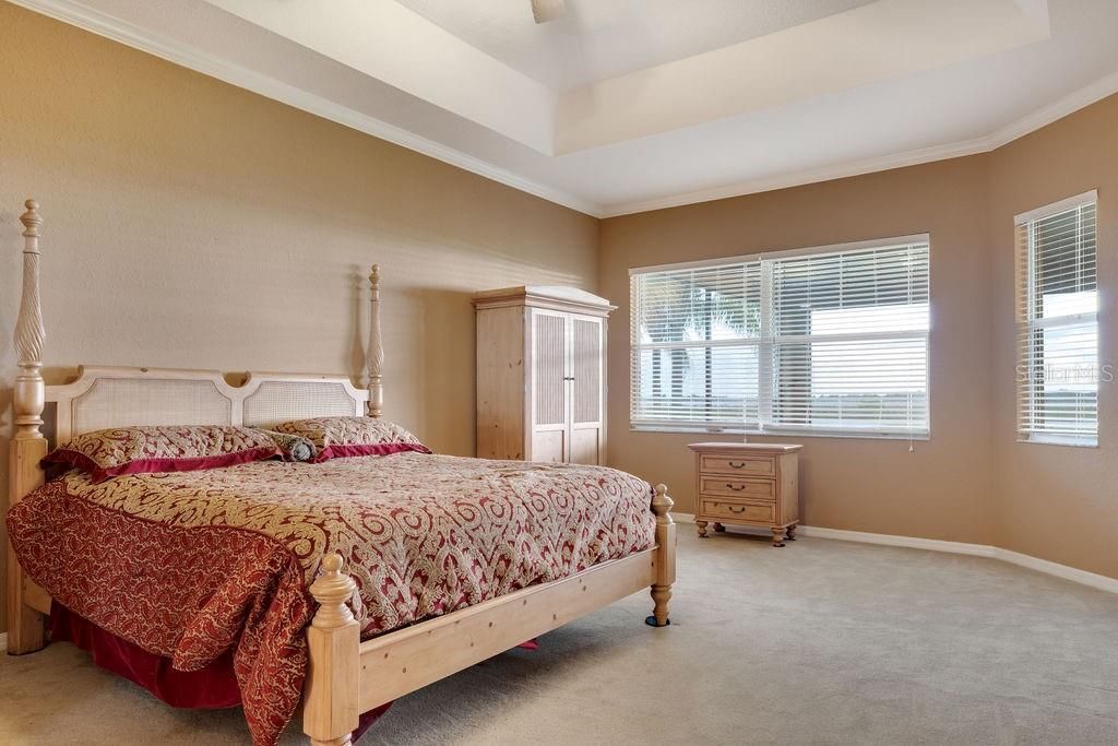 Master bedroom extended to provide for additional leisure room. Picture window overlooks lanai and provides the stunning view of the golf course, pond and Lake Ashton.