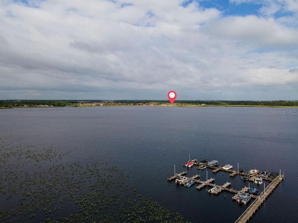 Overhead view of house as related to the marina. It is across the lake as denoted by the red balloon.