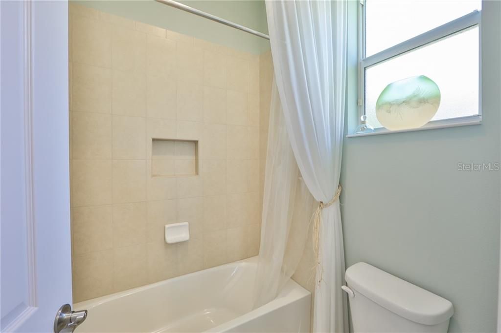 The tub/shower combination also enjoys natural light and clean lines.