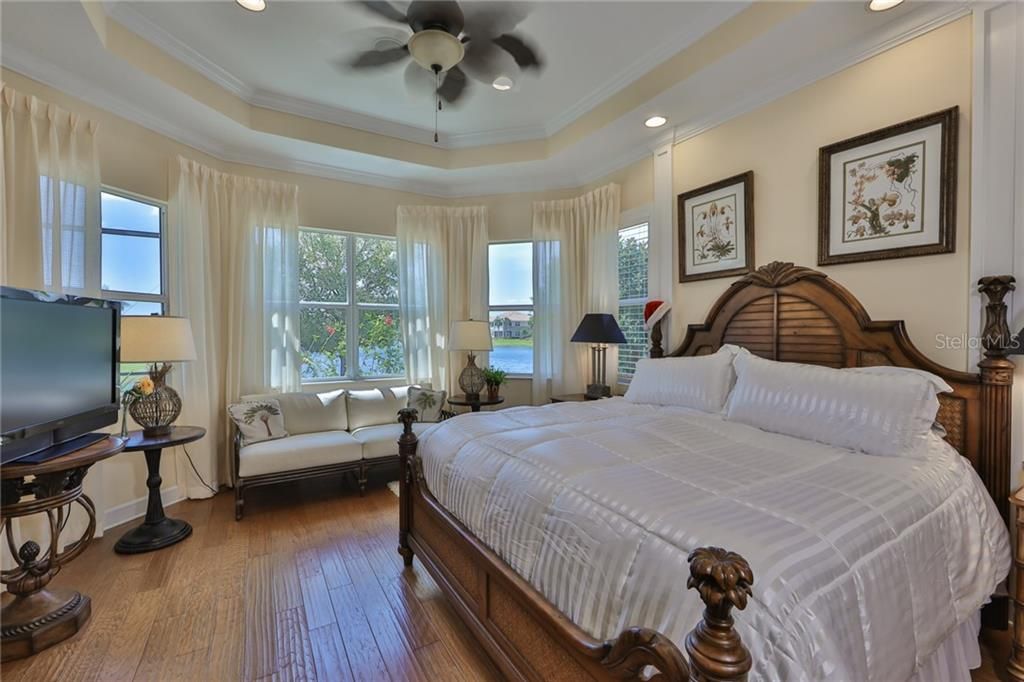 Crown molding, tray ceiling, custom wood trim are only a few of the upgrades that this stunning bedroom can boast about.