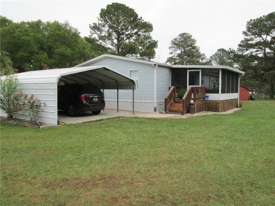 Back of home with carport