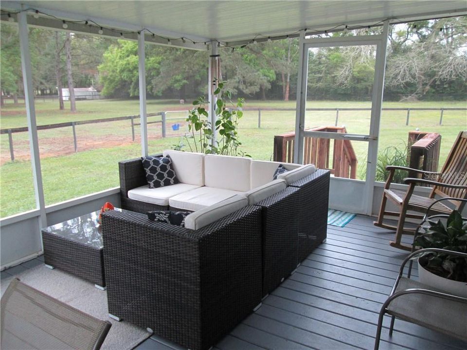 Screened and covered porch with view of pasture