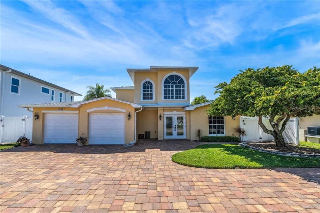 Beautiful 3 BR, 3 BA, 2 Car Garage, 2,769 Sq Ft Waterfront Home with Circular Driveway, Newer Seawall and Dock with 16K lb Boat Lift and 2 PWC Swinger Lifts
