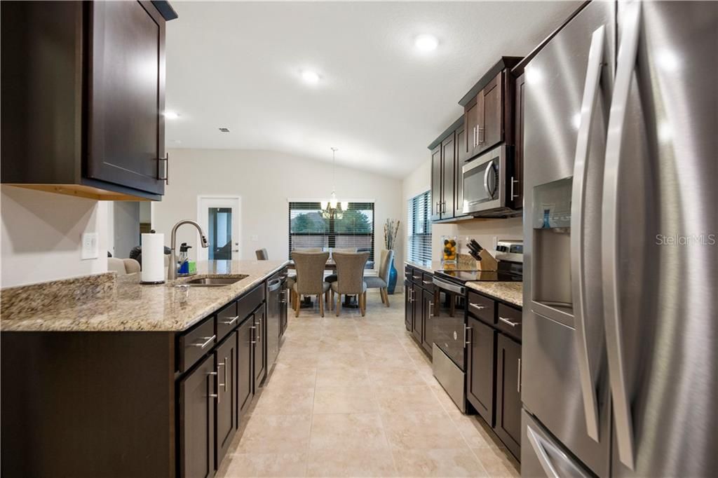 Gleaming stainless steel appliances, granite counter tops and wood cabinets make this kitchen just what you want.