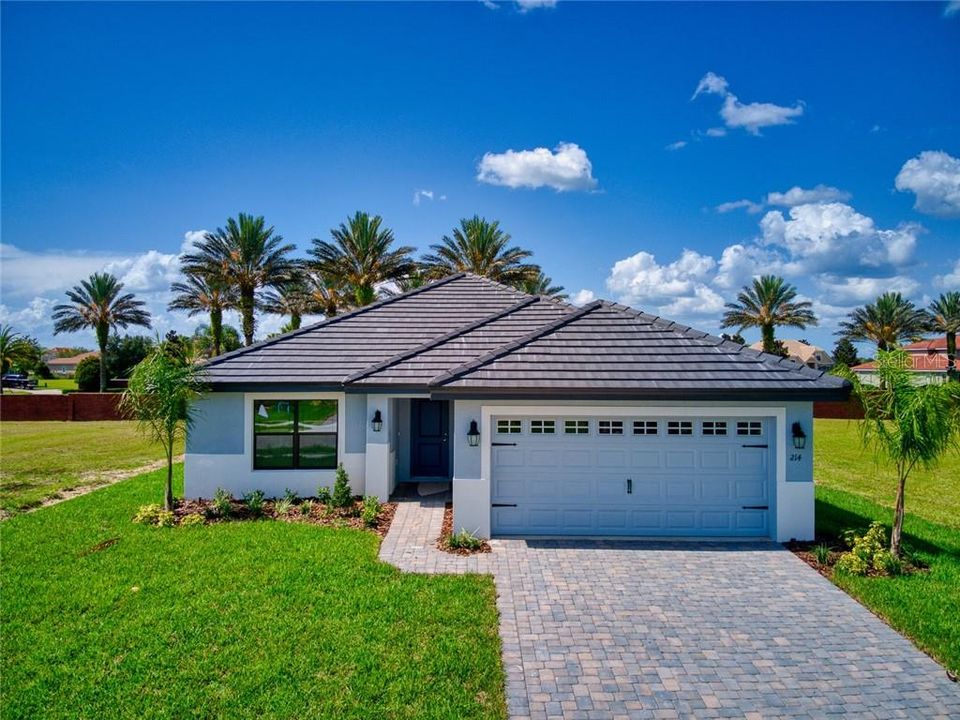 This home is only seven months old! Owners added extras features after moving into this upscale home built with tile roof, brick driveway and located in a gated two Lake community one mile from  I-4.