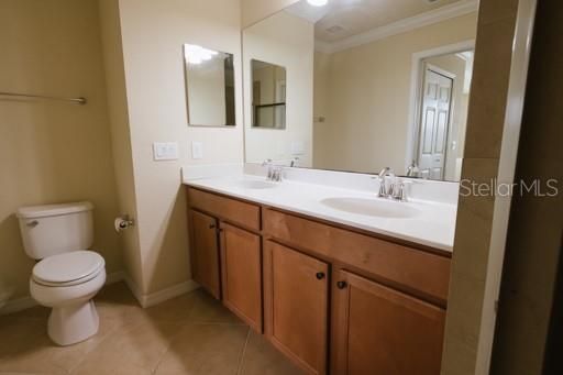 Owners' bathroom with dual sinks and shower.