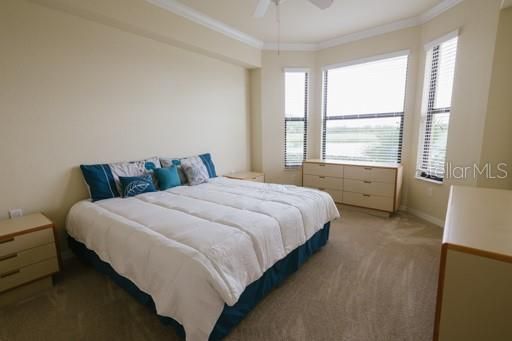 Owners' bedroom with lake and golf course view.
