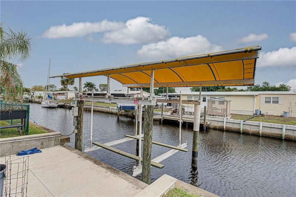 Concrete dock, boat lift and canopy.......just needs your boat!