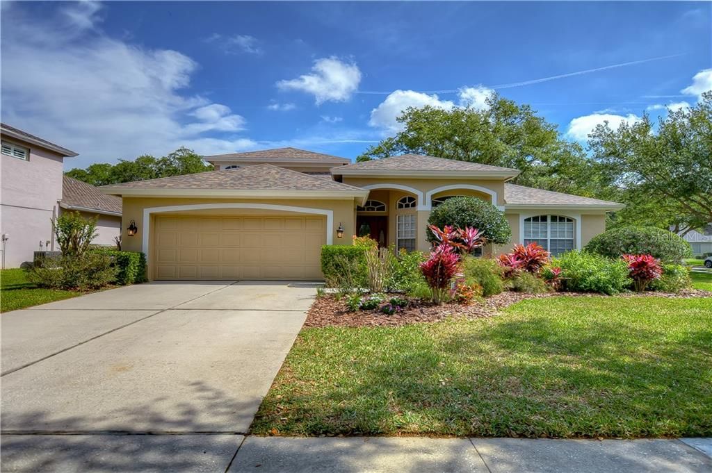This beautiful home located in the gated River Hills community is sitting on a spacious corner lot and offers tons of privacy while still having views of the golf course!