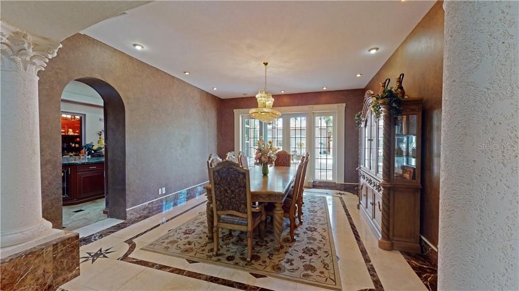 Notice the marble baseboards and decorative marble inlay design in the flooring.