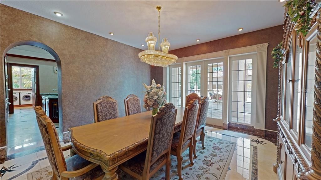 Private dining room with french doors to the lanai for entertaining.
