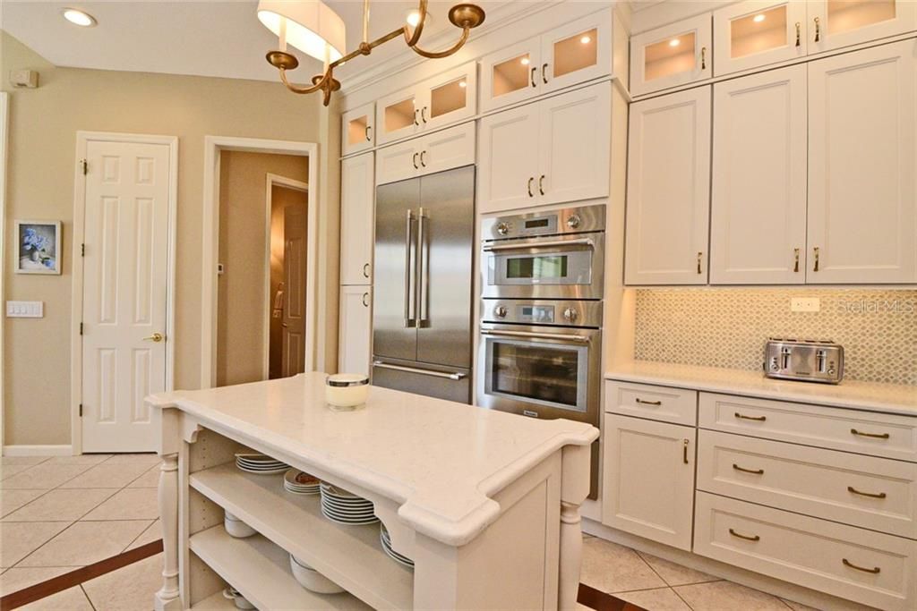 Stainless Steel Appliances and lighted glass top cabinets