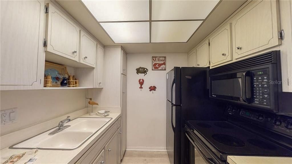 This kitchen has plenty of cabinet space, newer all black appliances and a double sink.