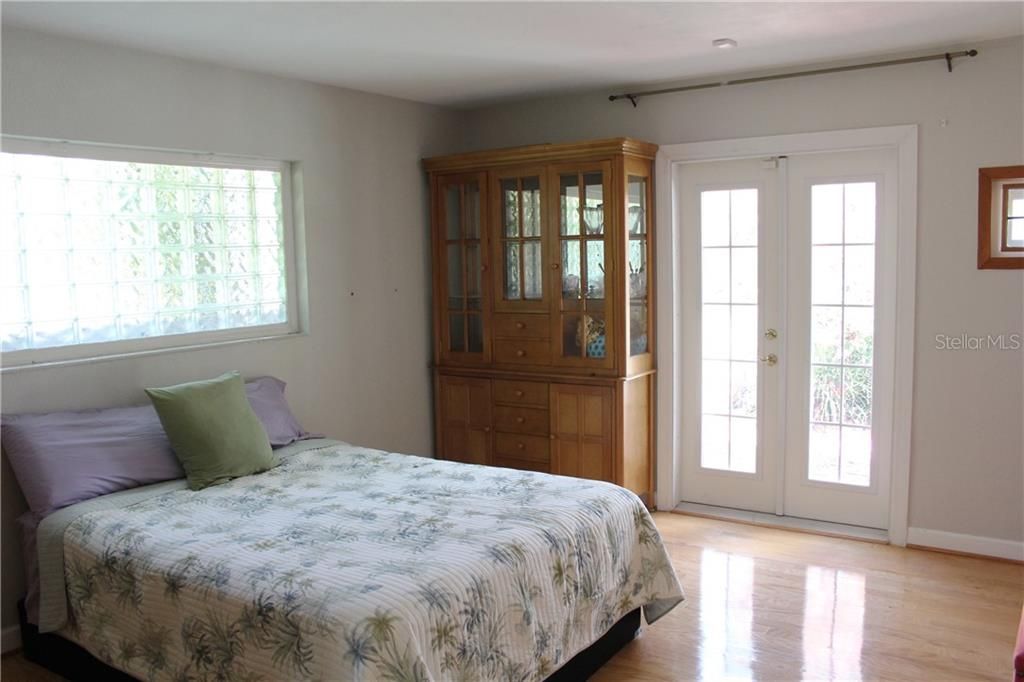 Master bedroom with French door access to the back patio and pool
