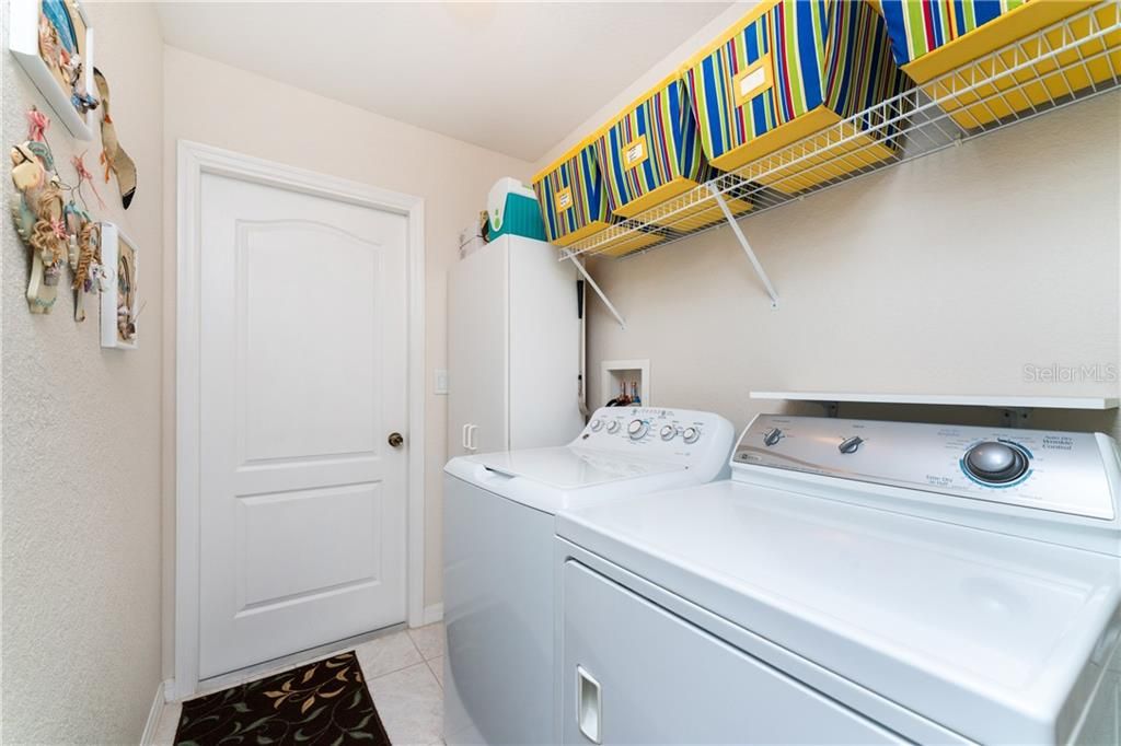 The indoor laundry room is conveniently located adjacent to the kitchen (washer/dryer will convey with sale of property).