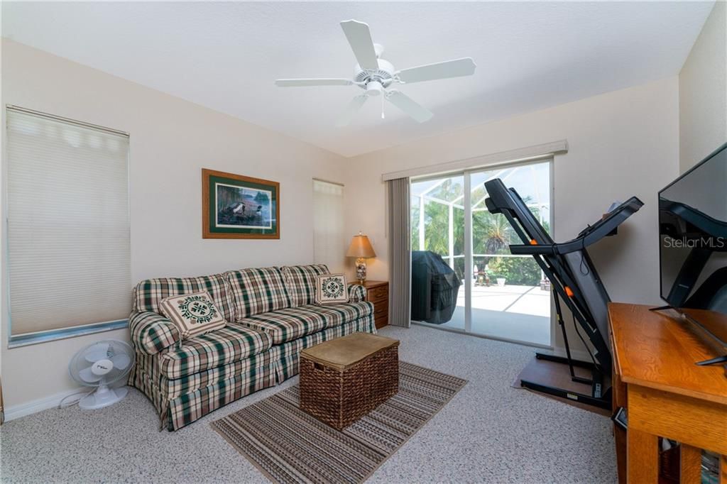 Guest bedroom 3 offers easy access to the pool/lanai with sliders.