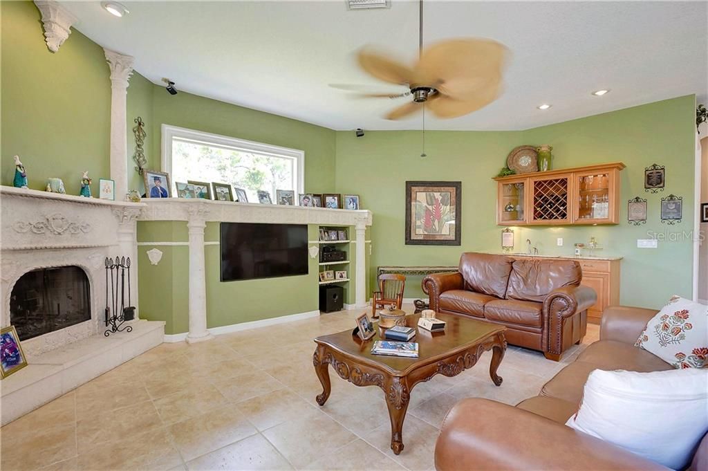 Spacious family room with wet bar and wine rack.