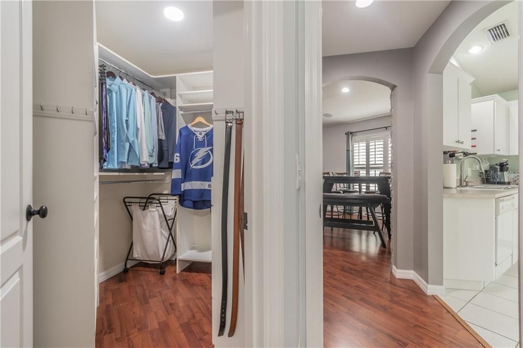 looking into the walk-in master closet and hallway to kitchen & family room