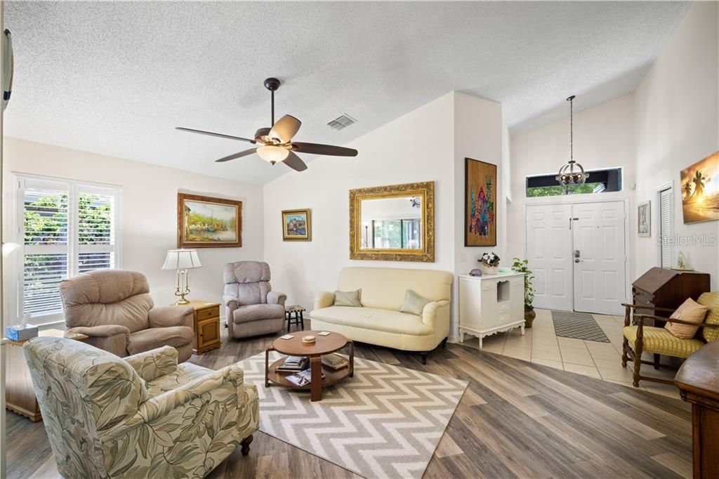 Great Room with vaulted ceilings and newer waterproof vinyl flooring. Light and bright!
