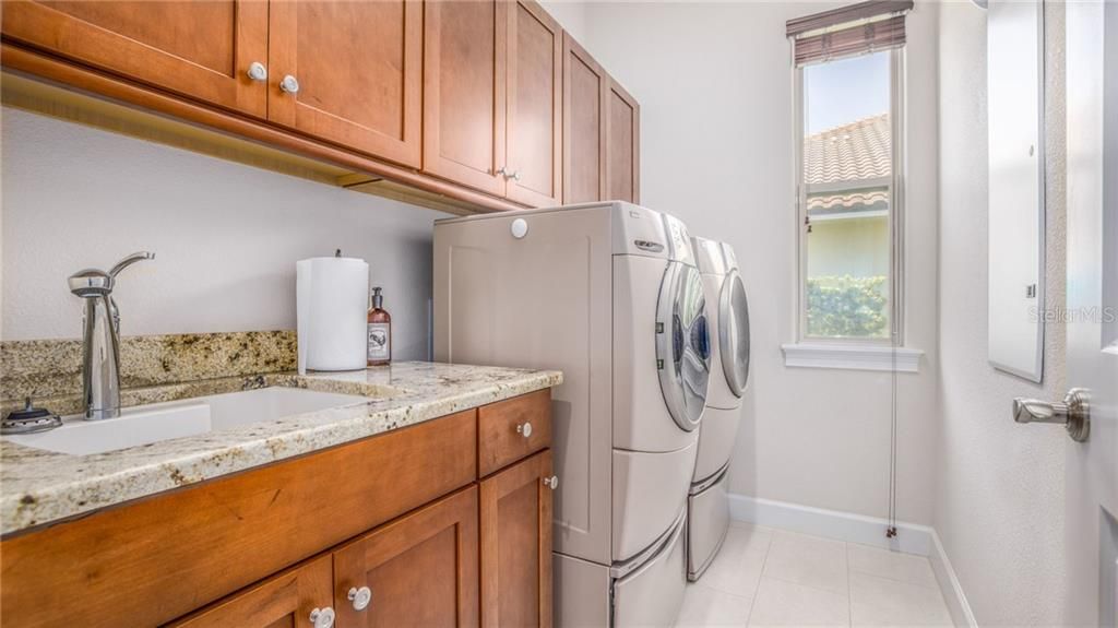 There are two laundry areas. This is the laundry room downstairs just off the kitchen and the hallway leading to the third garage