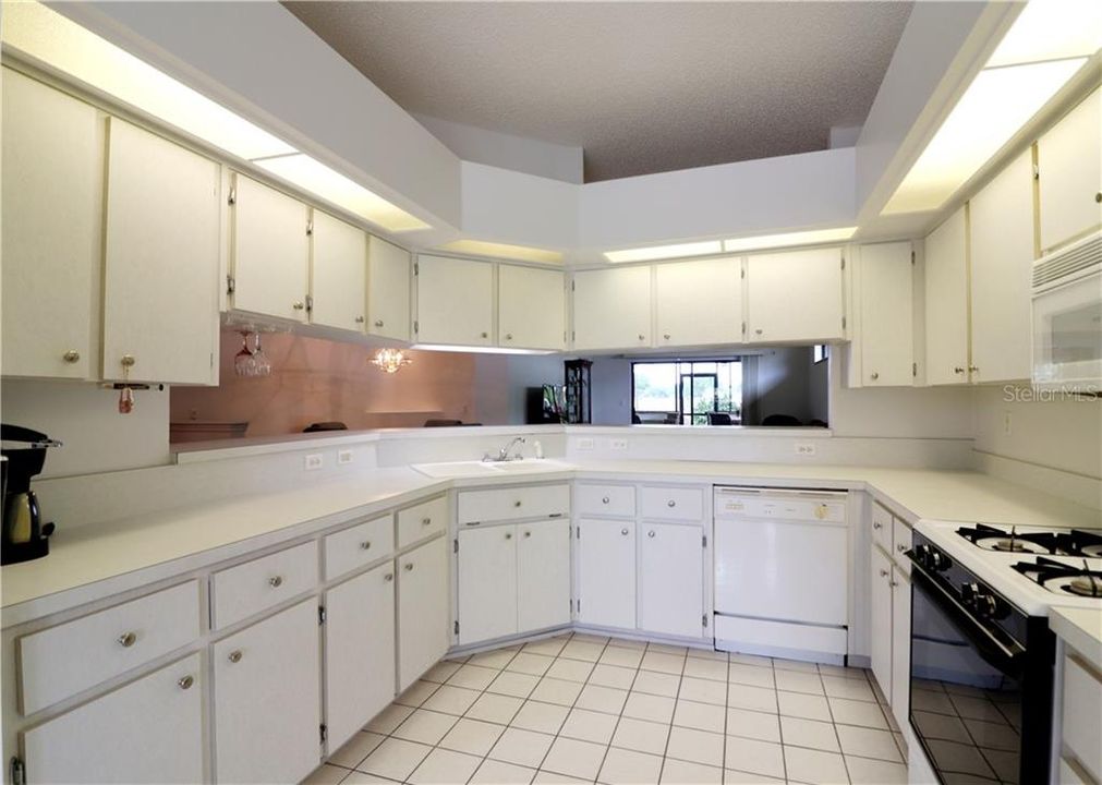 KITCHEN WITH GAS RANGE,  BUILT-IN MICROWAVE, NEW GARBAGE DISPOSAL AND BREAKFAST BAR