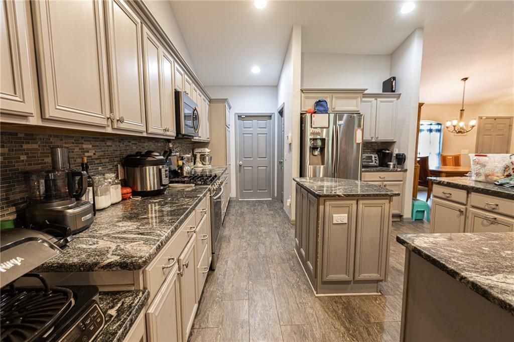 beautiful kitchen with granite tops and lots of cabinet space. stainless steel appliances