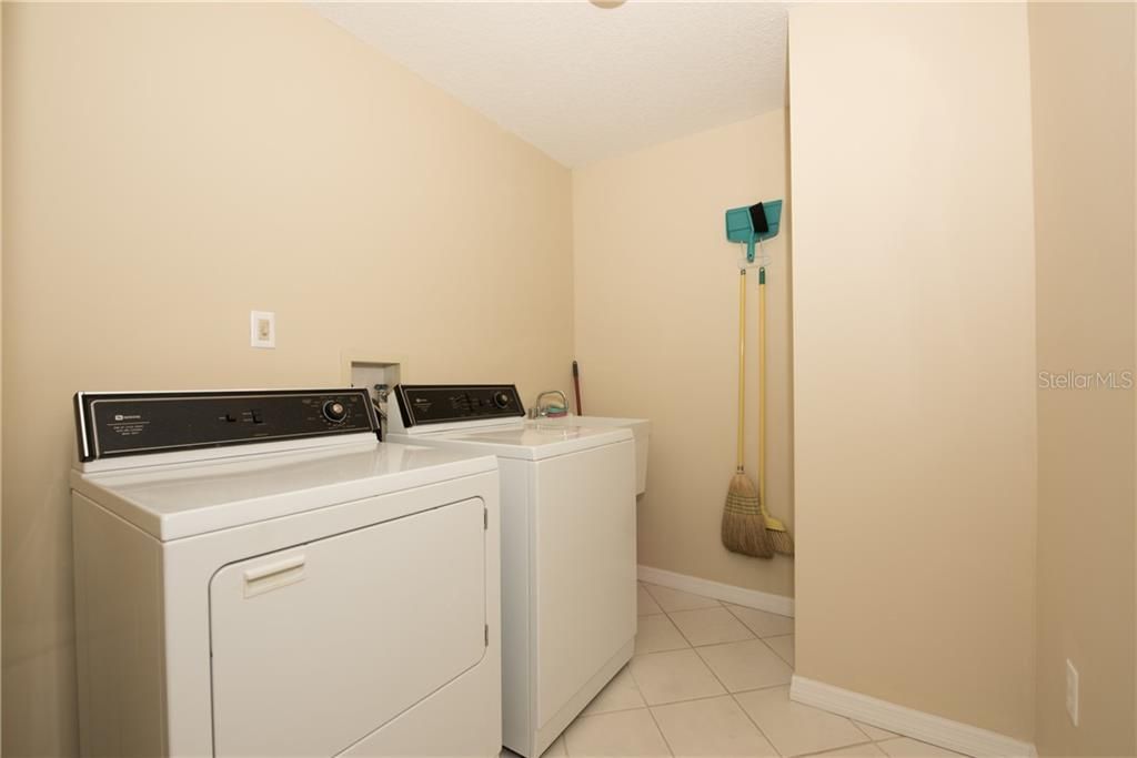 Wow! This is a condo with a large laundry room and a sink!