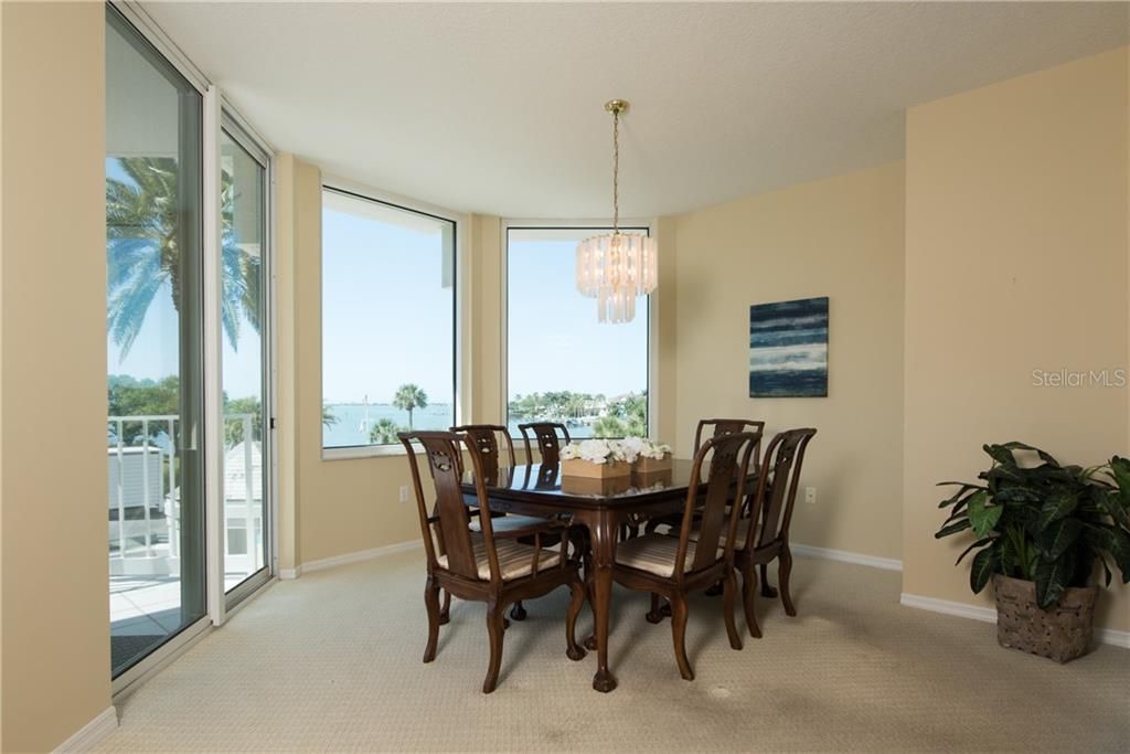 Large Dining room with sliding glass door to the balcony and big windows out to the water!