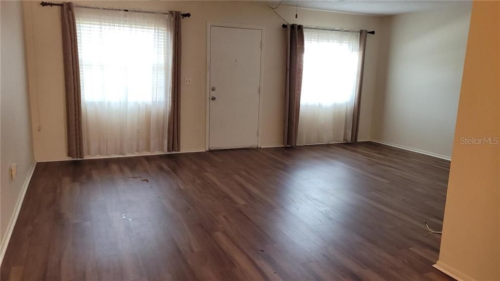 Generous sized living room with newer luxury plank vinyl flooring