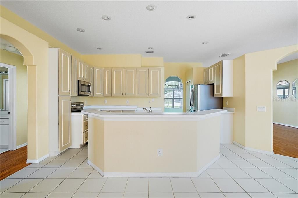 From this view, you have the additional Bedrooms to your left, the Formal Dining straight ahead and then the Formal Living and Master Suite to your right. This Kitchen is centered in the heart of the home!