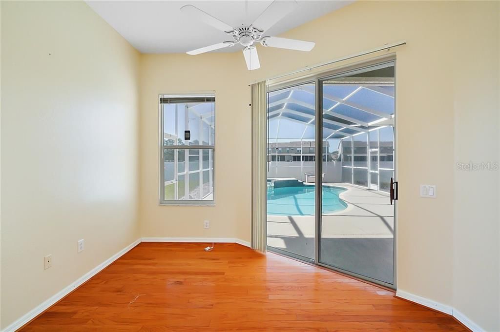 Flex Room - 11X10 - with wood flooring and sliders to your Pool and Patio, this Flex Space is so much more than an added 'sitting room'! This area can be a private office or exercise room with views of the Florida Sunshine over your private Pool and Patio!