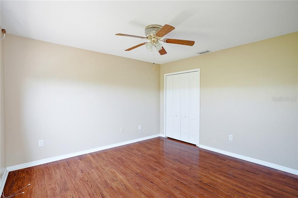2nd Bedroom - 12X11 - is located down the hall from the Family Room and across from the Pool Bath. This Bedroom also has the same laminate flooring and light, bright, neutral wall color.