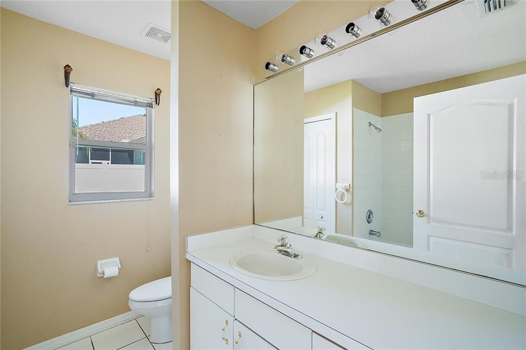 Bathroom - 08X07 - is just steps away from the Family Room and is located between the 3rd and 4th Bedrooms. This bathroom has good counter space and provides a tub with a shower plus a linen closet.