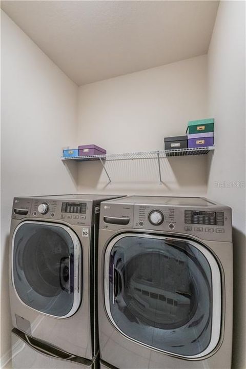 Utility room with LG Deluxe washer / dryer and pedestals